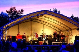Band playing onstage outdoors