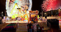 Nighttime midway long shot with Ferris Wheel blurred in motion